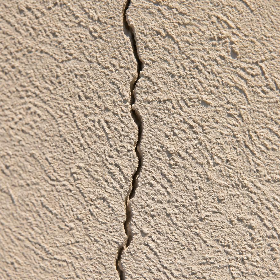 Hairline crack running through painted exterior stucco